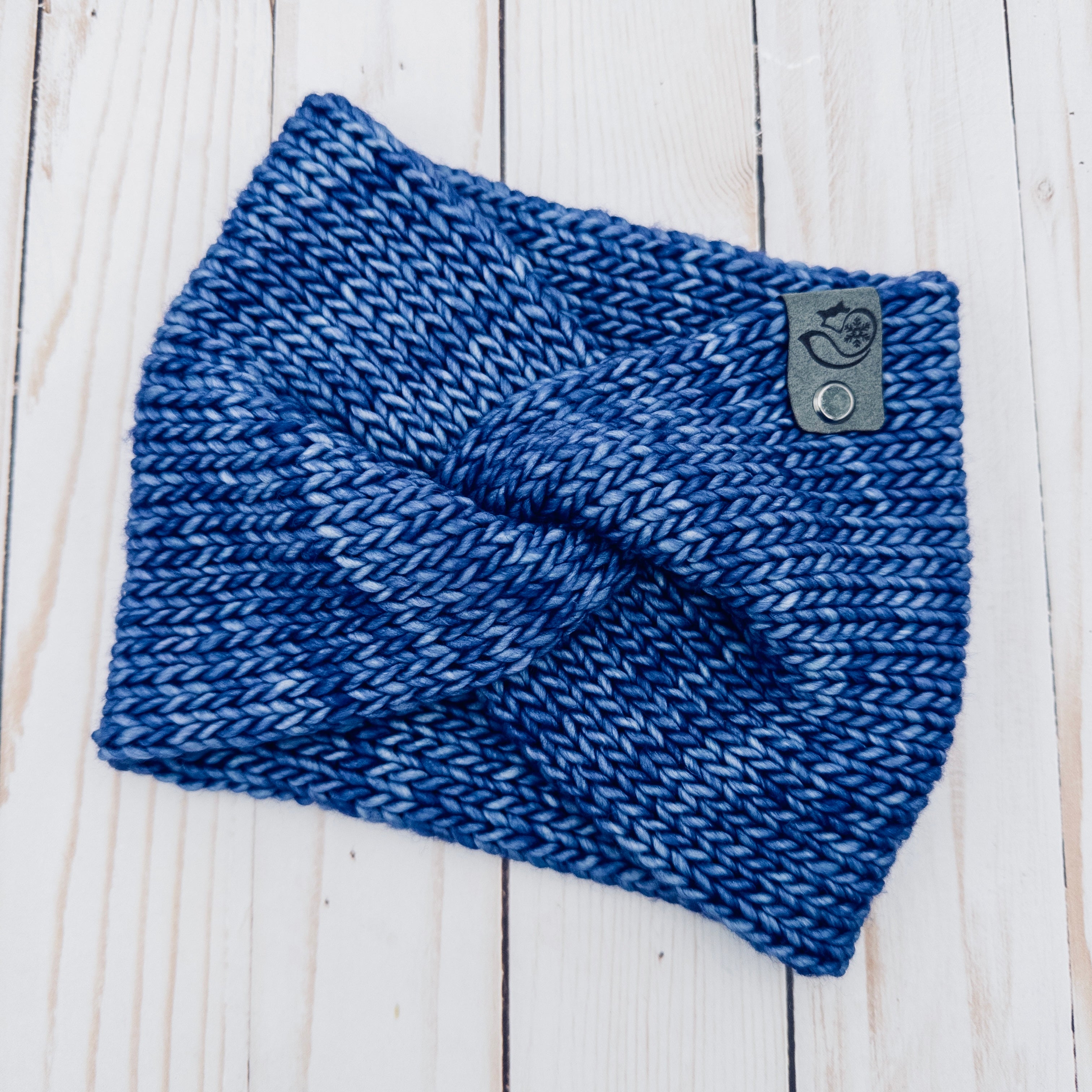 Hand knit Mecha merino wool twist headband in London Sky colorway featuring rich tonal blue hand-dyed merino wool