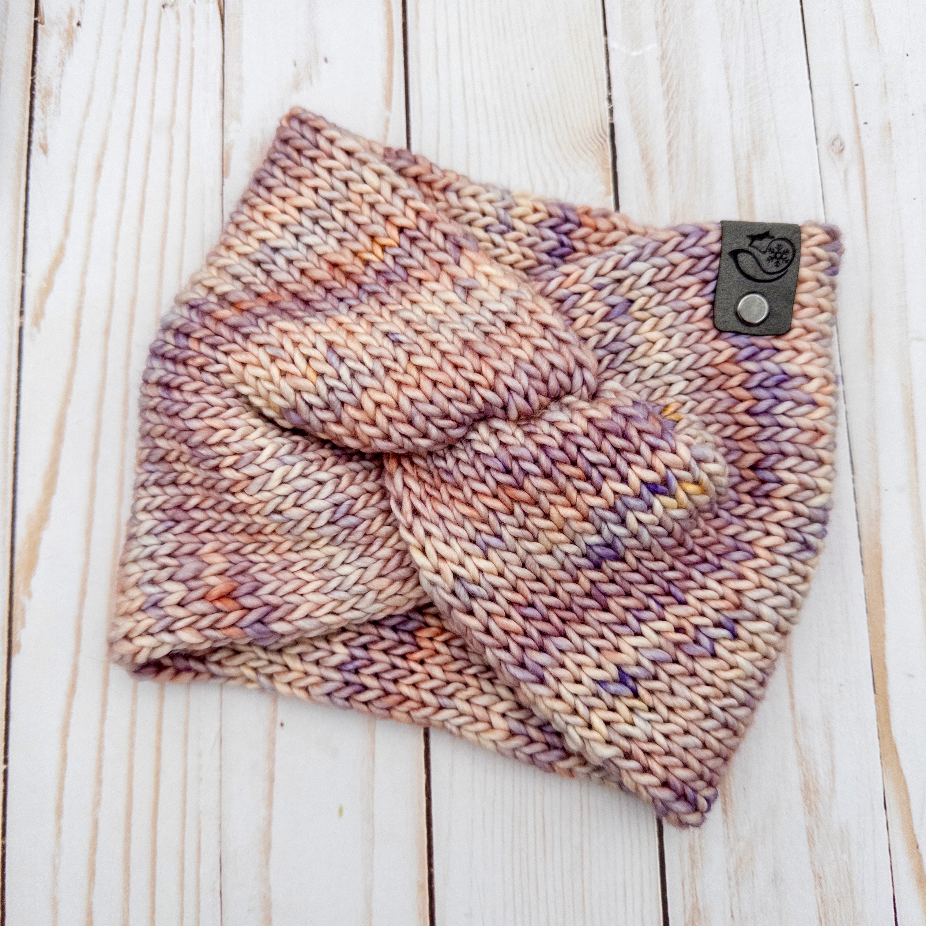 Hand knit Mecha merino wool twist headband in Zelda colorway featuring soft blush, lavender, cream, and peach tonal variation